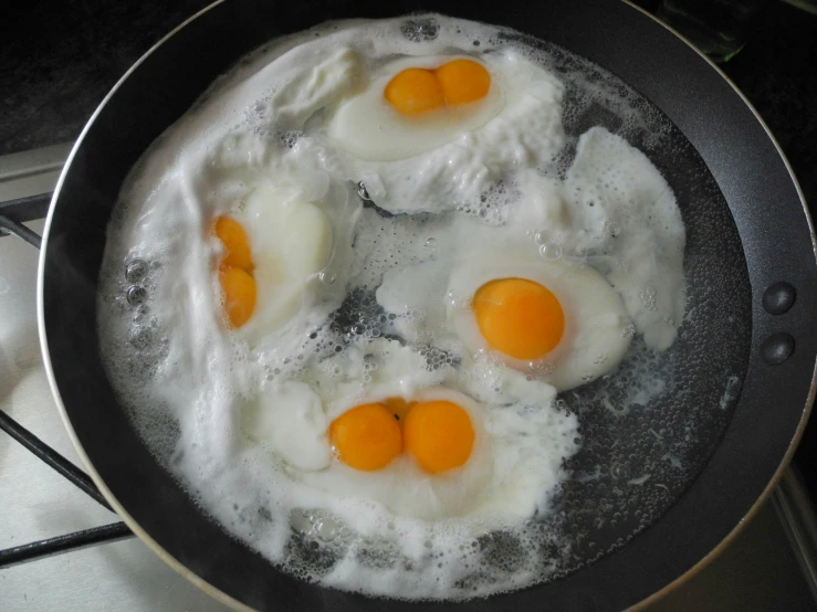 three eggs are cooked and sitting in a pan
