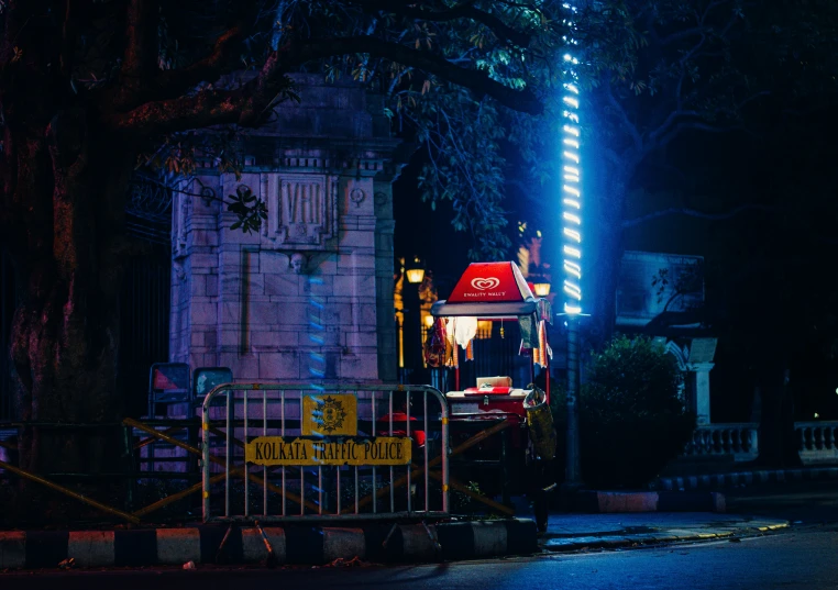 a clock tower sitting next to a light pole