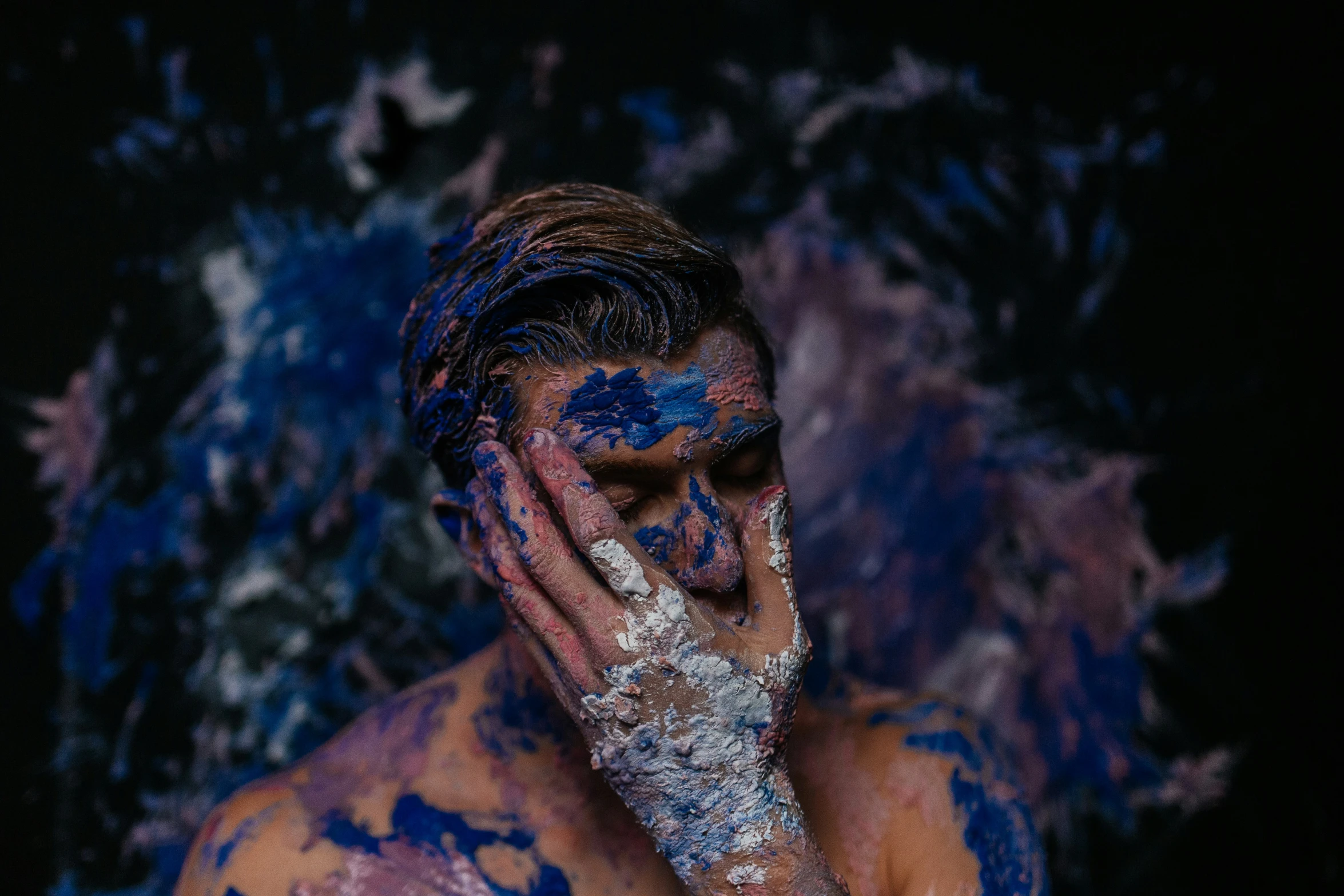 a man covered in blue and white food on his face