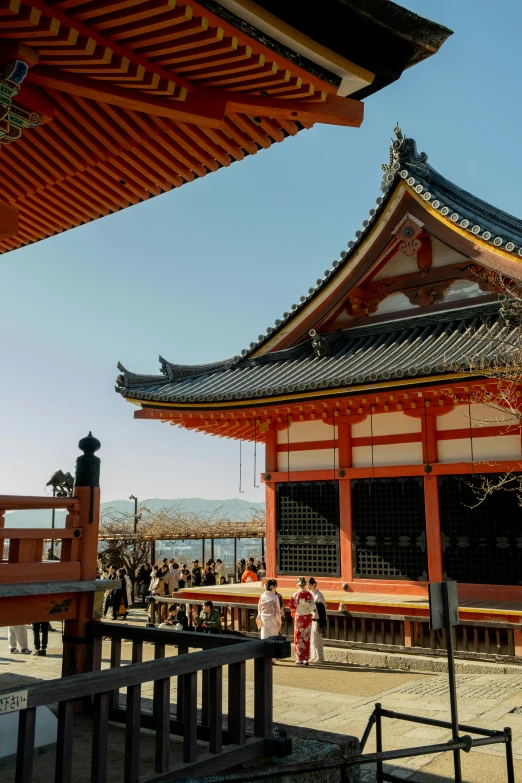 people are standing in front of an asian building