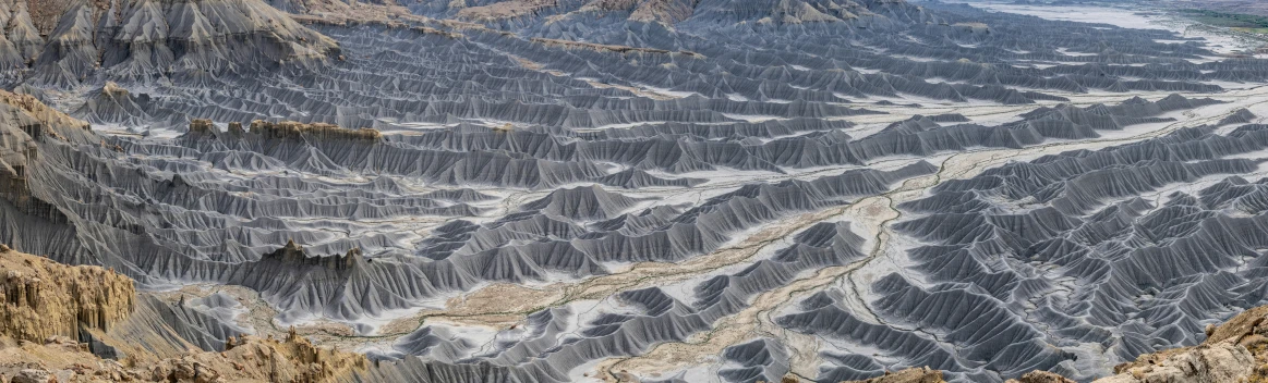 the landscape of mountains with a road painted on it