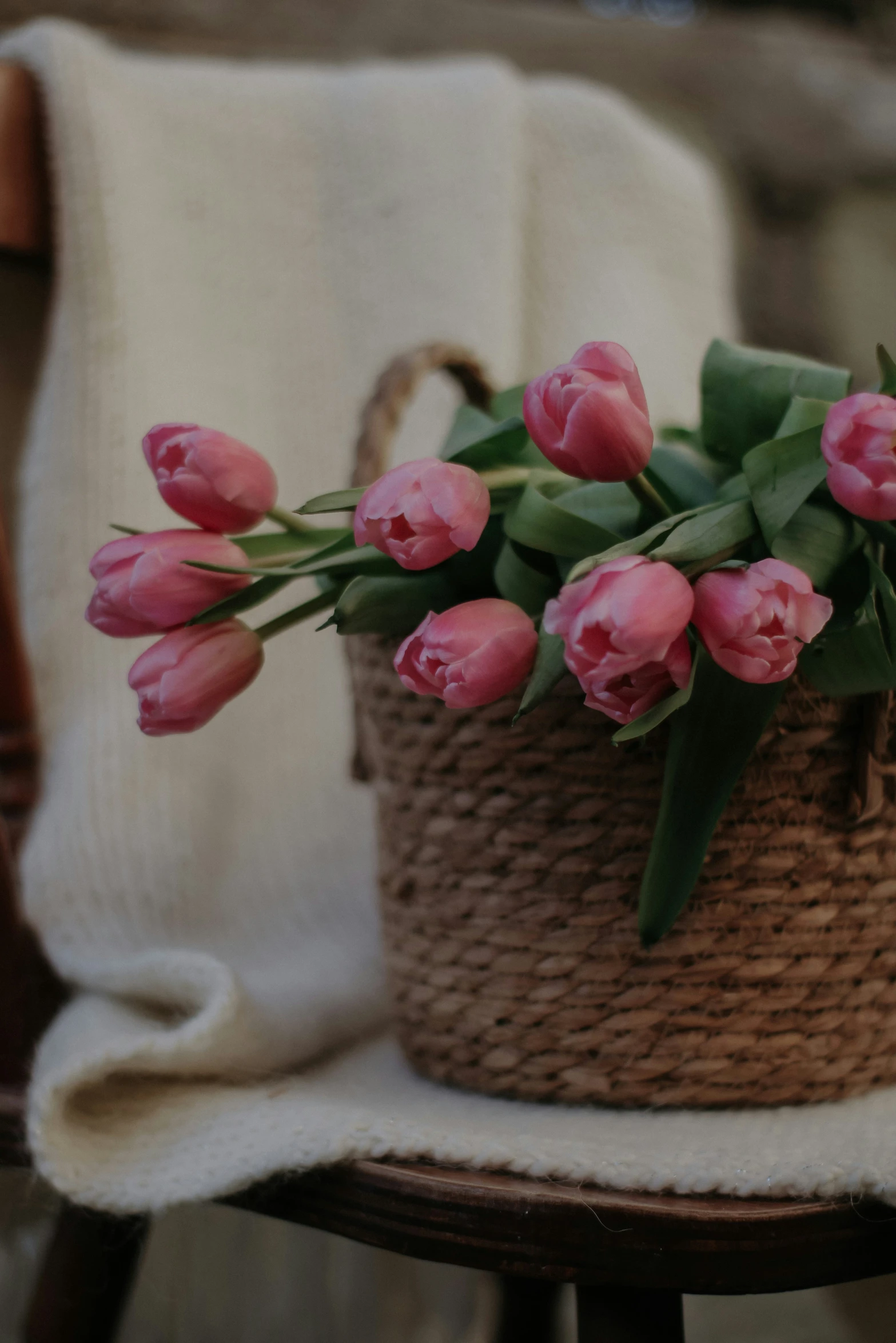 a vase with flowers inside on a small chair