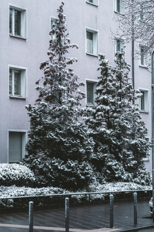 a tall building with many windows next to a street