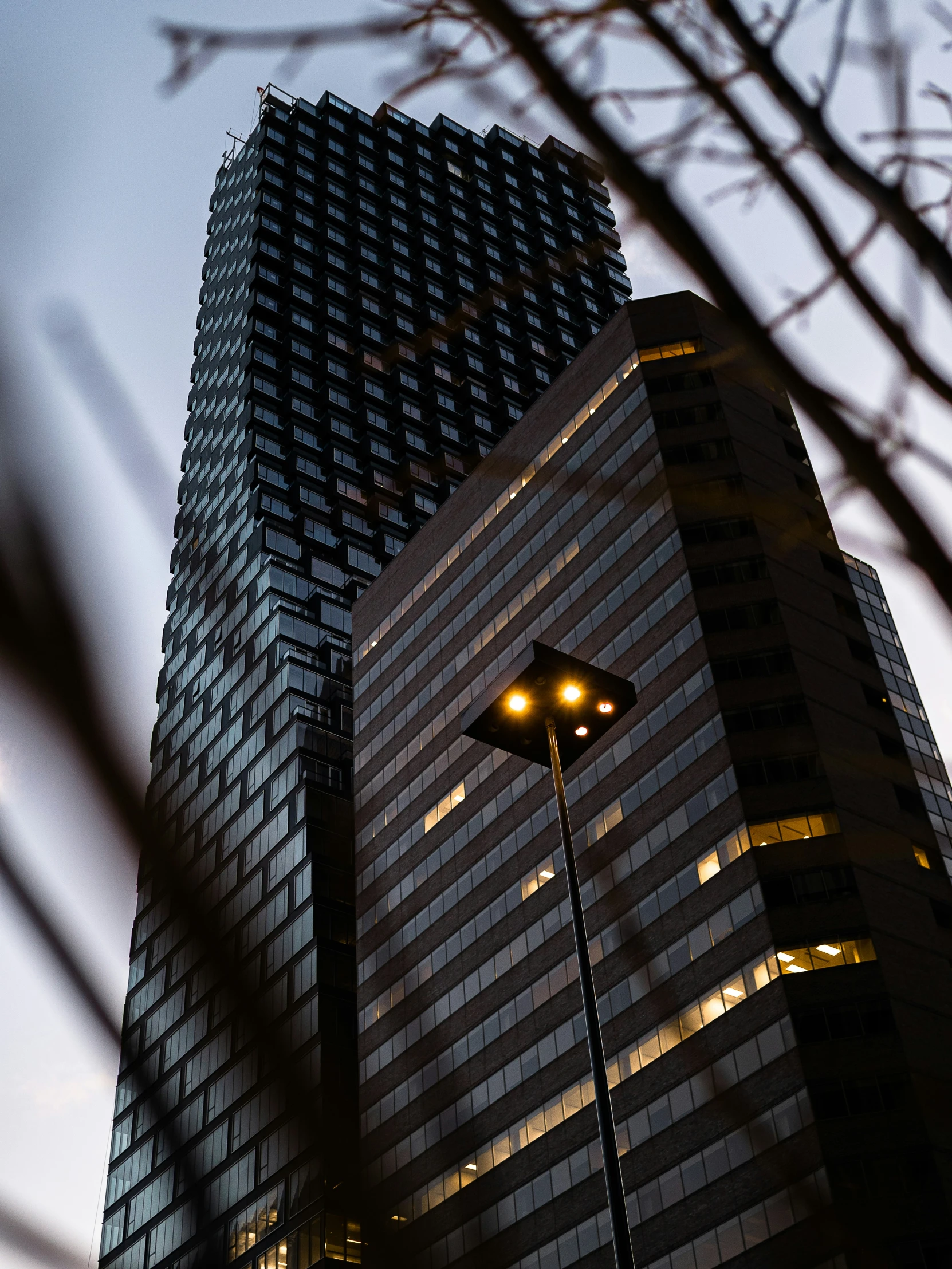 an empty street with a large tall building in the background