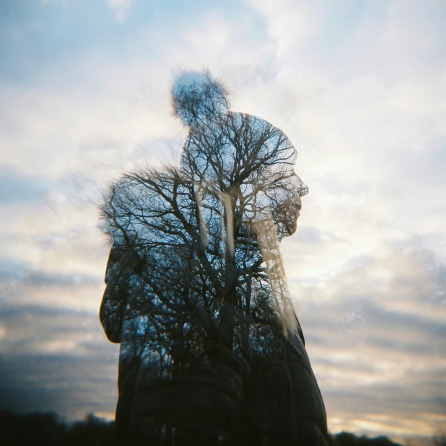 a man standing in front of a tree