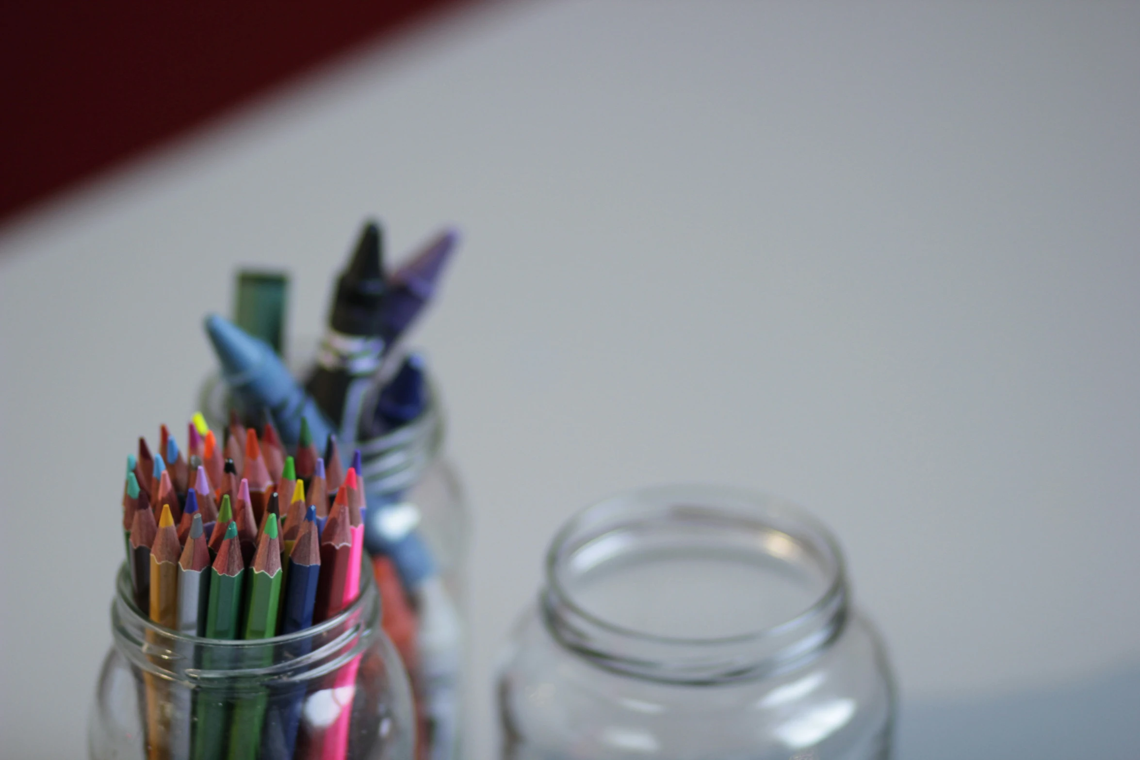 a couple of jars with different types of pens