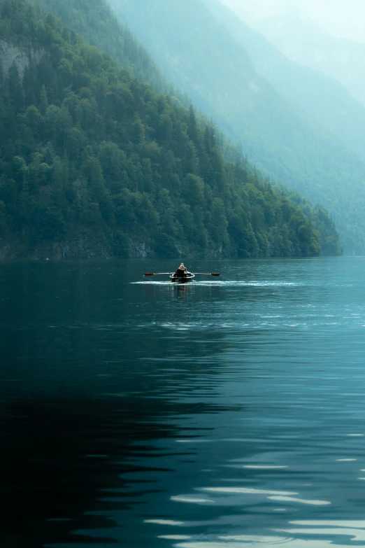 there is a lone person rowing a canoe