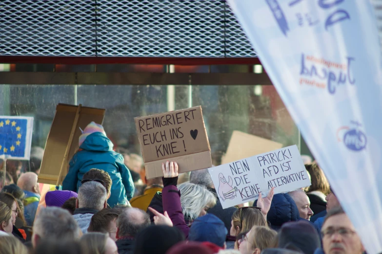 protesters holding placards with the phrase democracy etc kik