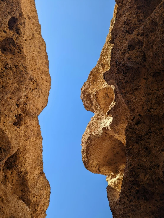 the sky above two stone formations next to each other