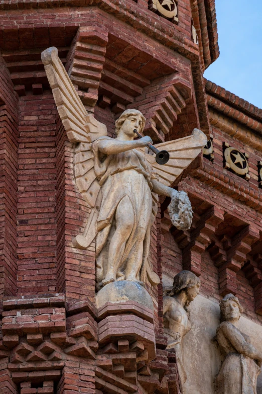 the sculptures of angels are on display in front of the building