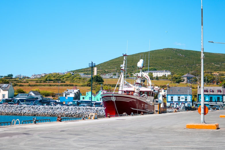 a brown and red boat docked in water