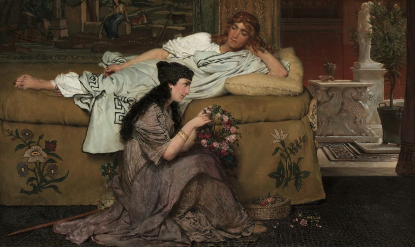 two women laying on a sofa talking to each other