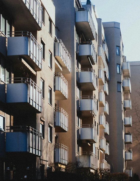 an apartment building with balconies and balconies hanging from the top