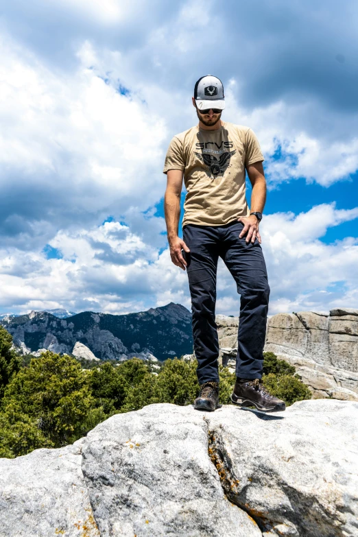 a man on top of a mountain on a sunny day