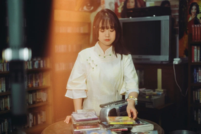 a woman looks through magazines on her desk