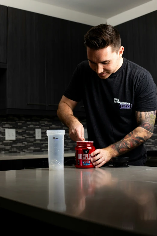 a man stands at a counter with a soda cup