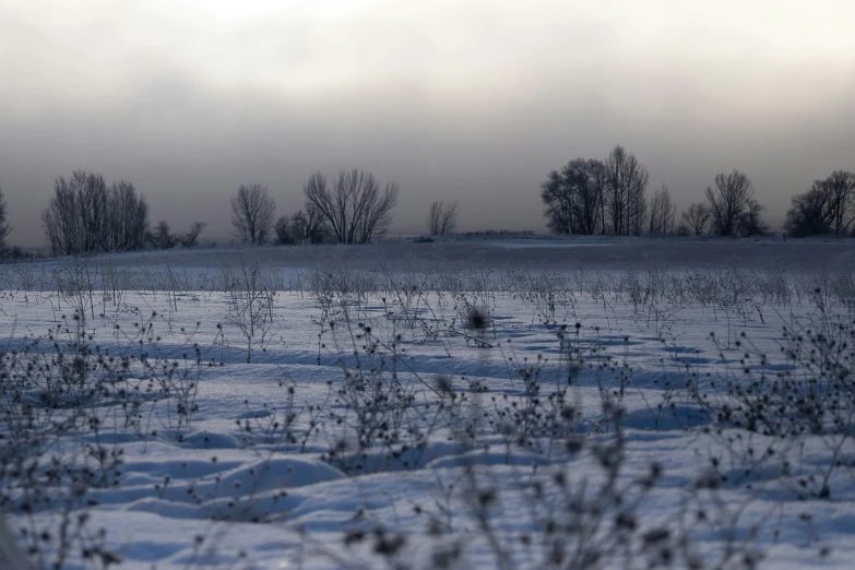 a view of a snowy landscape with a sky and clouds