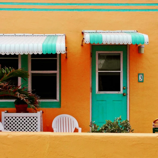 colorful doors, a bench and chairs outside a house