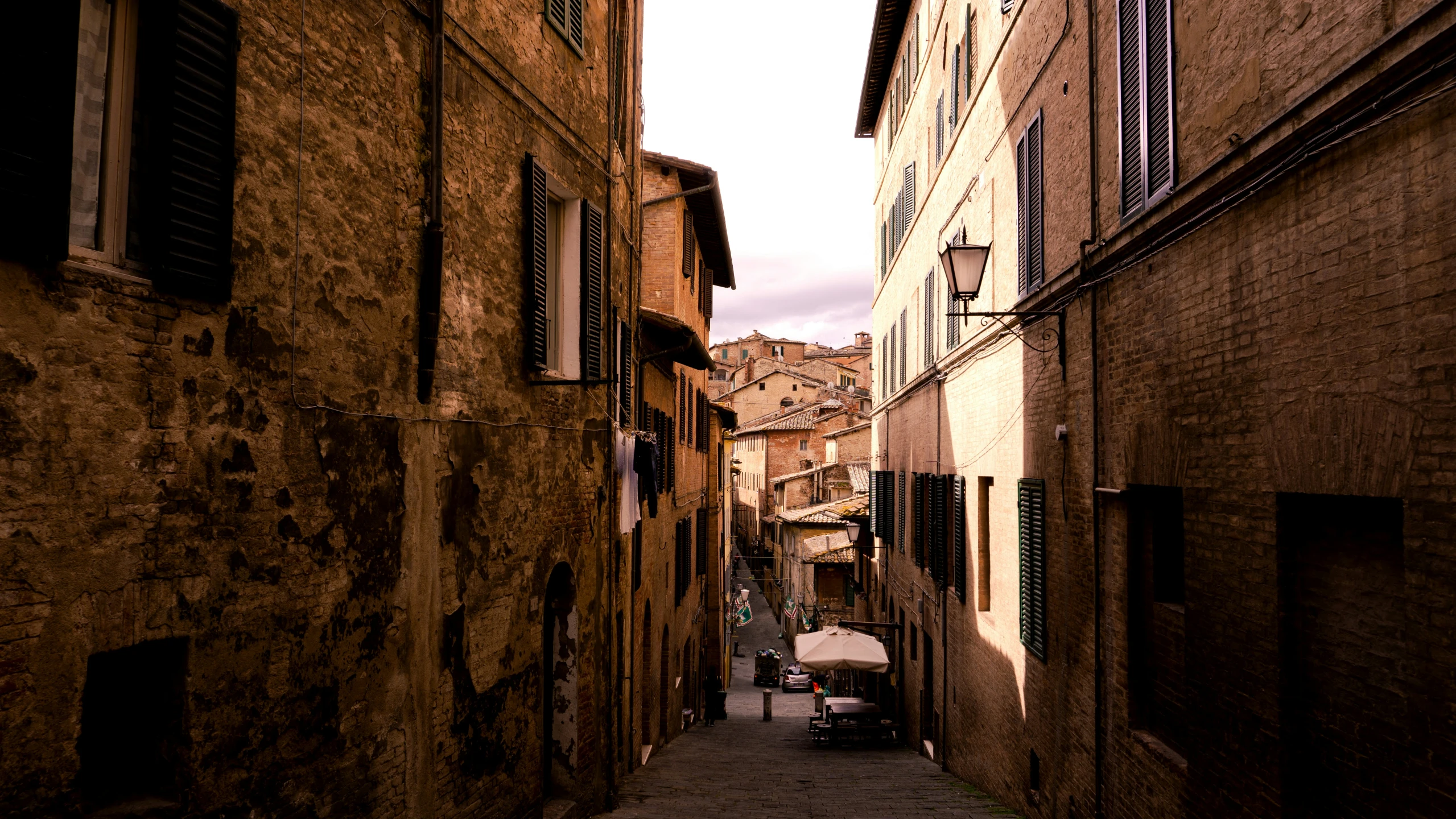 an alley with a baby carriage in between the two buildings