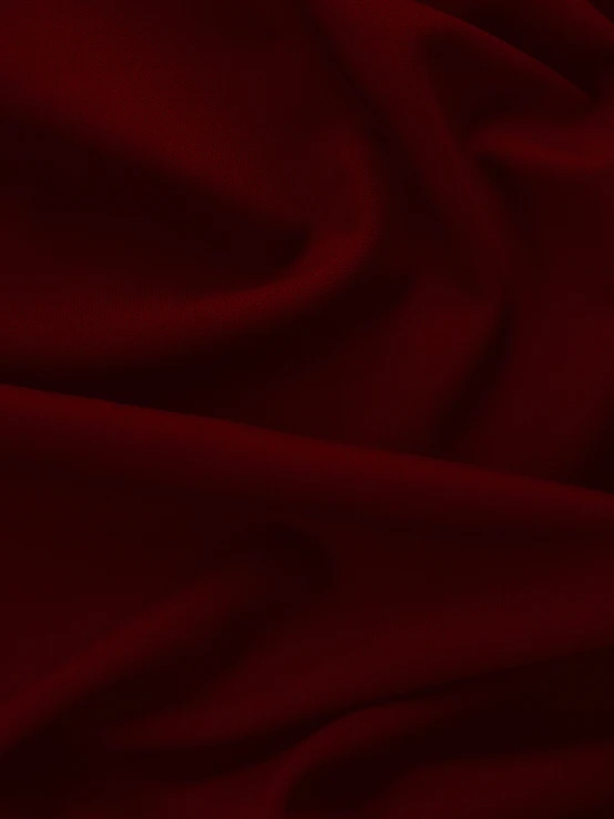 an extreme closeup image of a dark red fabric