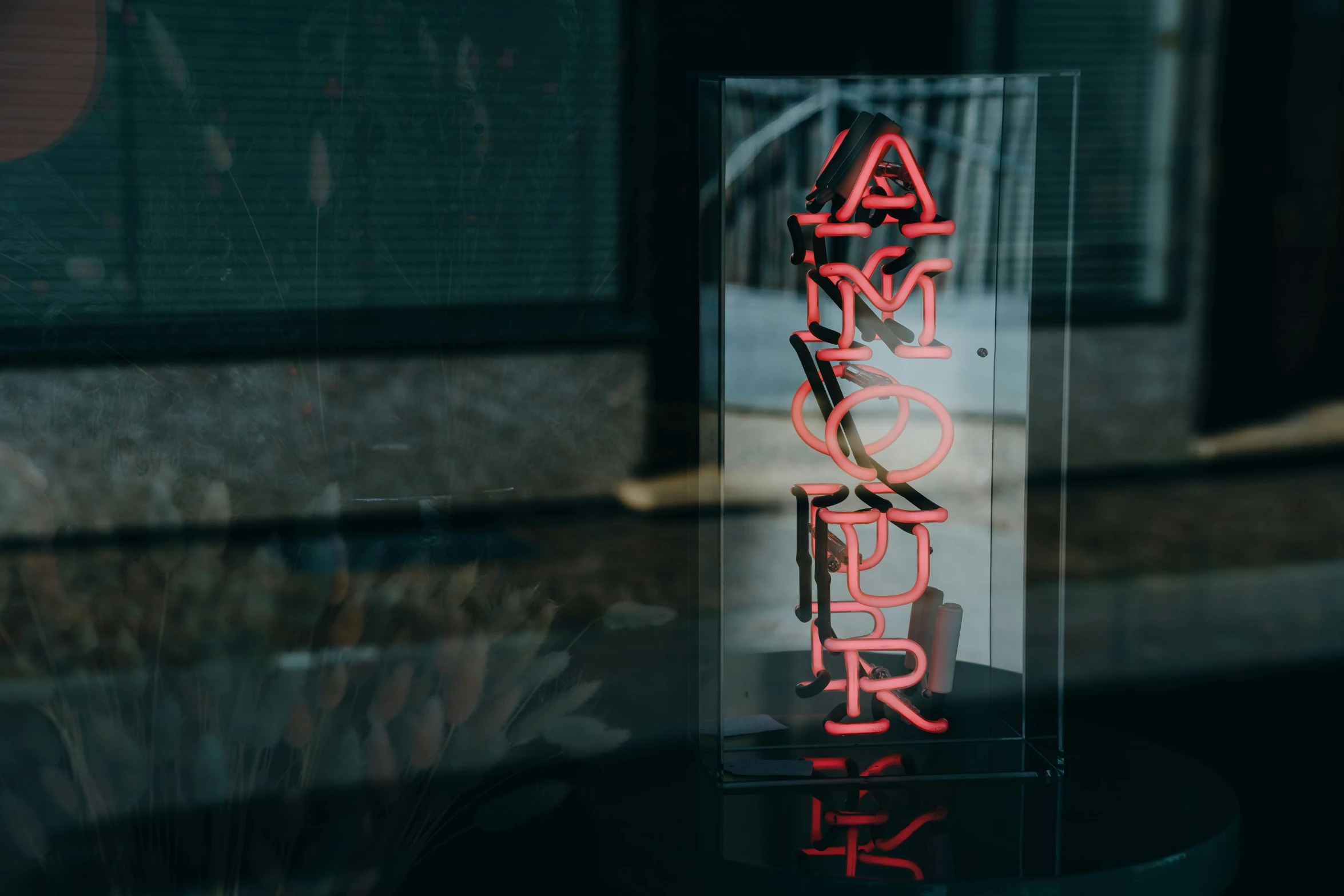 a large glass sign is lit up on the outside