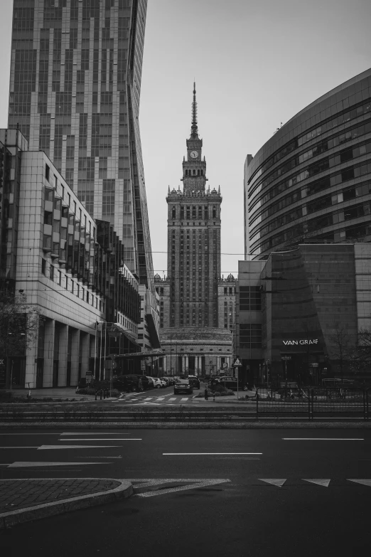 the empty road leading up to buildings in the city