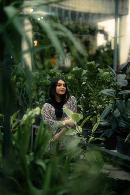 woman with hands in the air in a garden setting