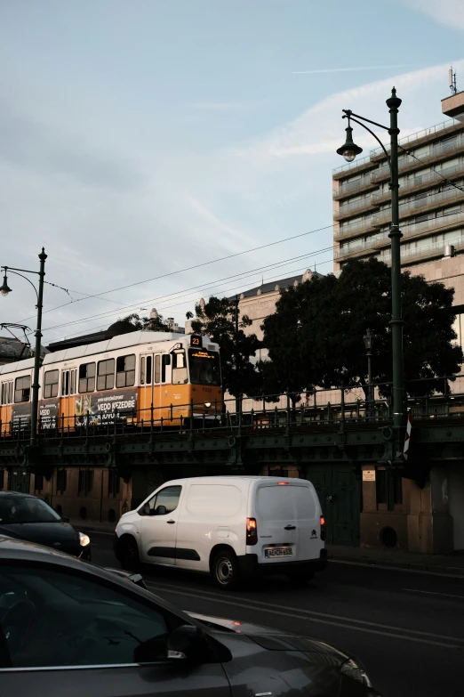 a train on train tracks and cars passing by