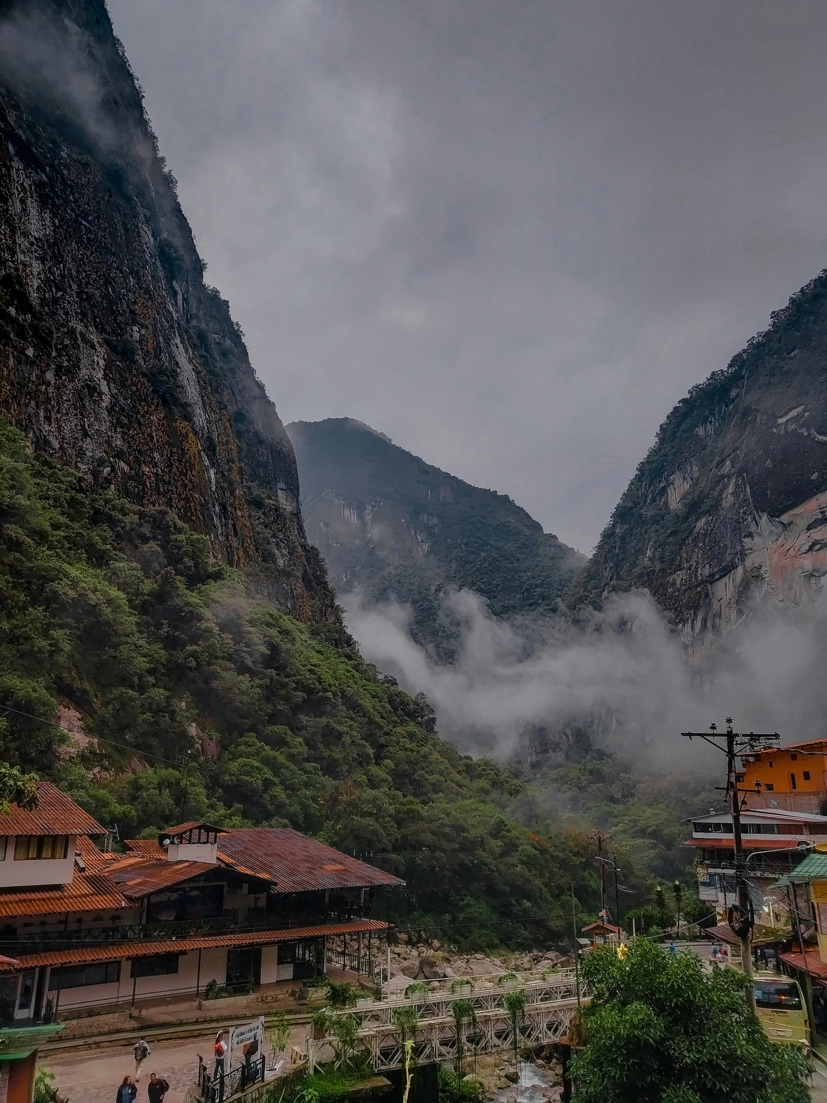 there is mountains in the background and buildings on each side