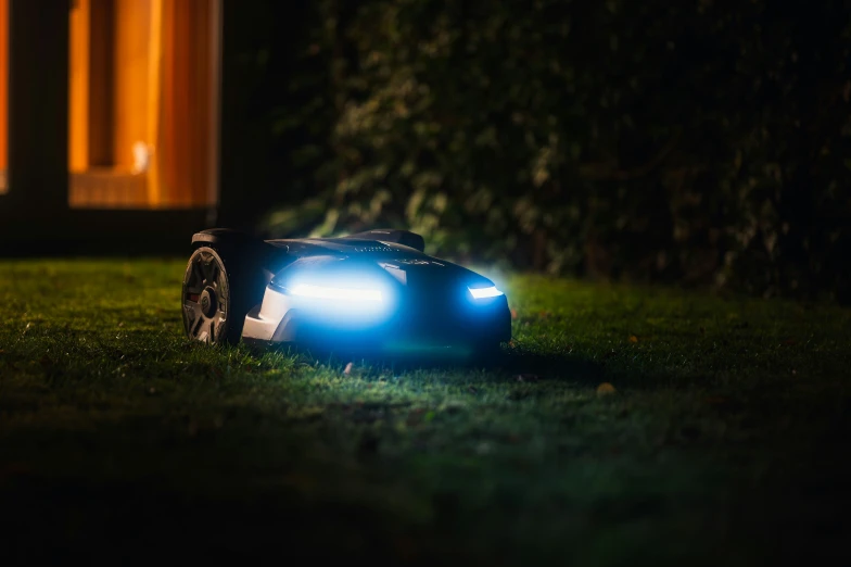 a car sitting outside with a spotless headlight on