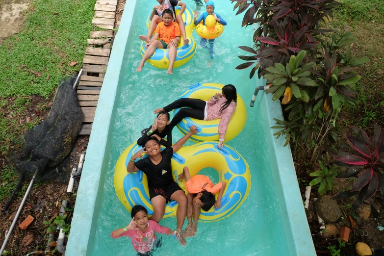 a group of children on an inflatable water slide