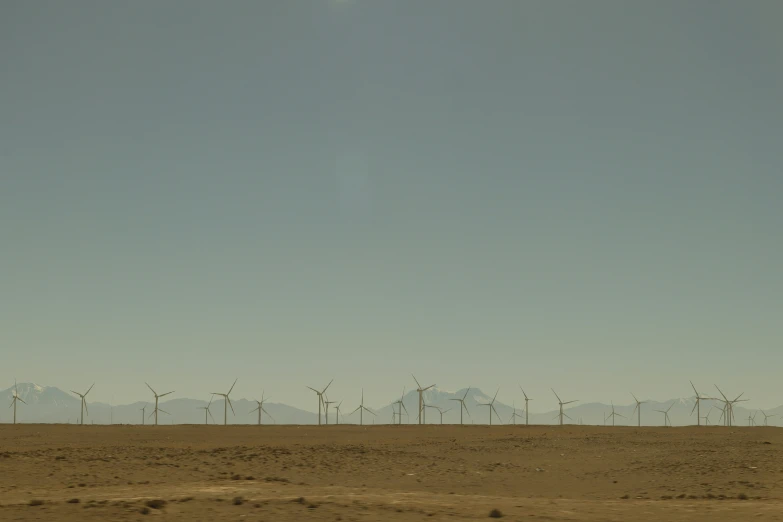 a vast desert area with some wind turbines