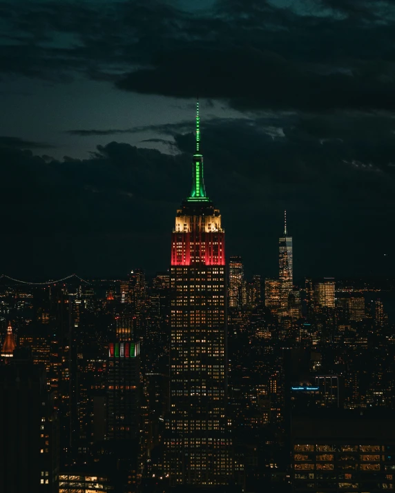 a large building with a green and red tower