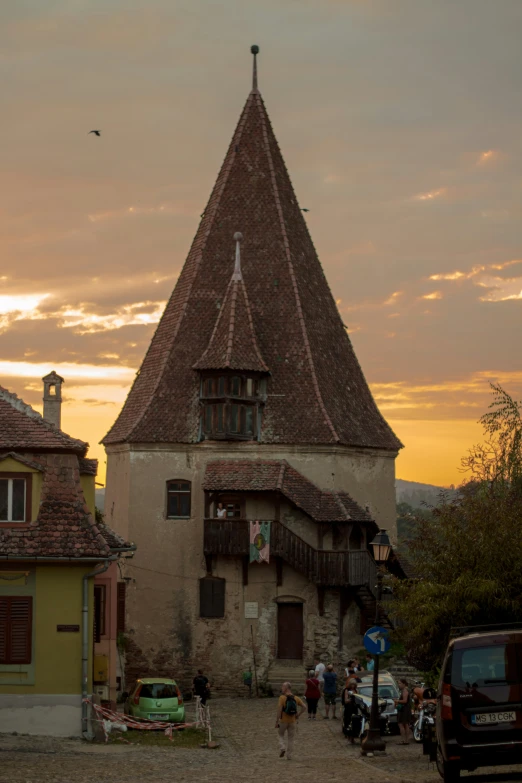 people are walking around a town near a house