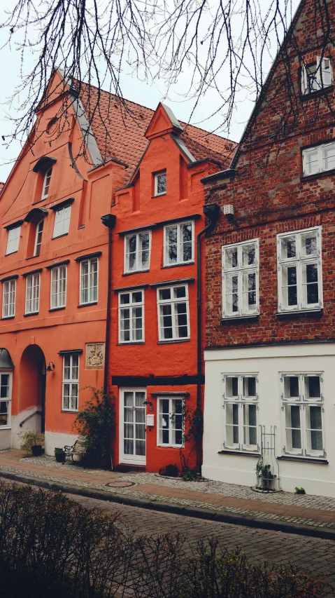 row of red brick building next to a river