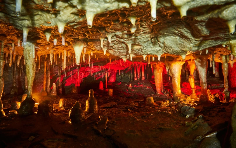 a long passageway in an underground cave with lights on the side