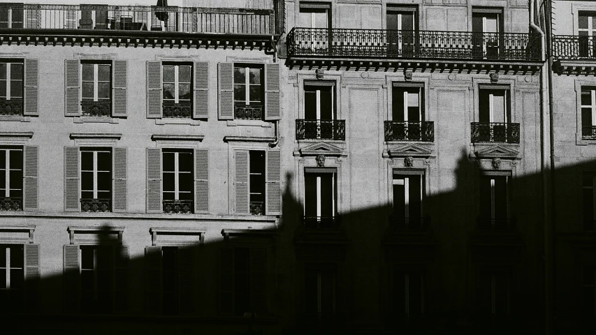 building with balconys and balconies in front of a fence