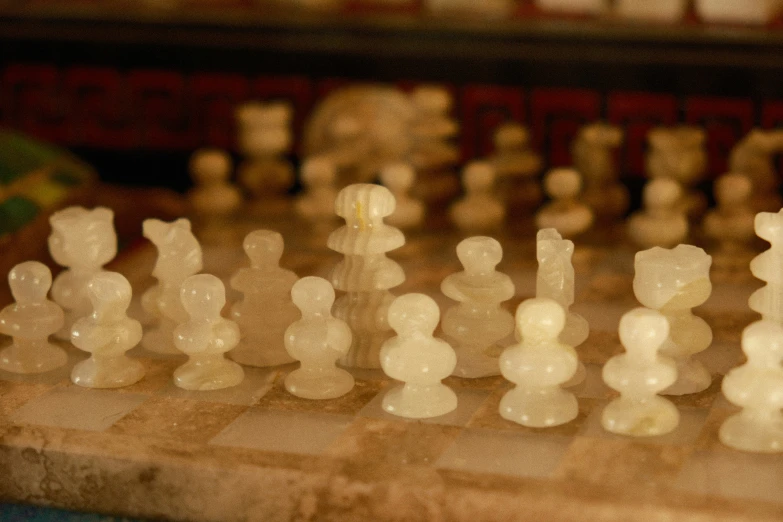 there are hundreds of white chess pieces on the board