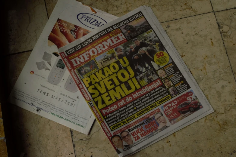 newspapers are laying on the ground on the street