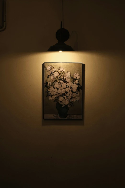 a wall hanging with flowers in a vase and an artwork