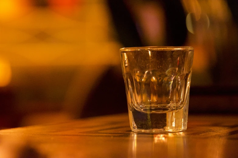 s glass sitting on table in restaurant setting