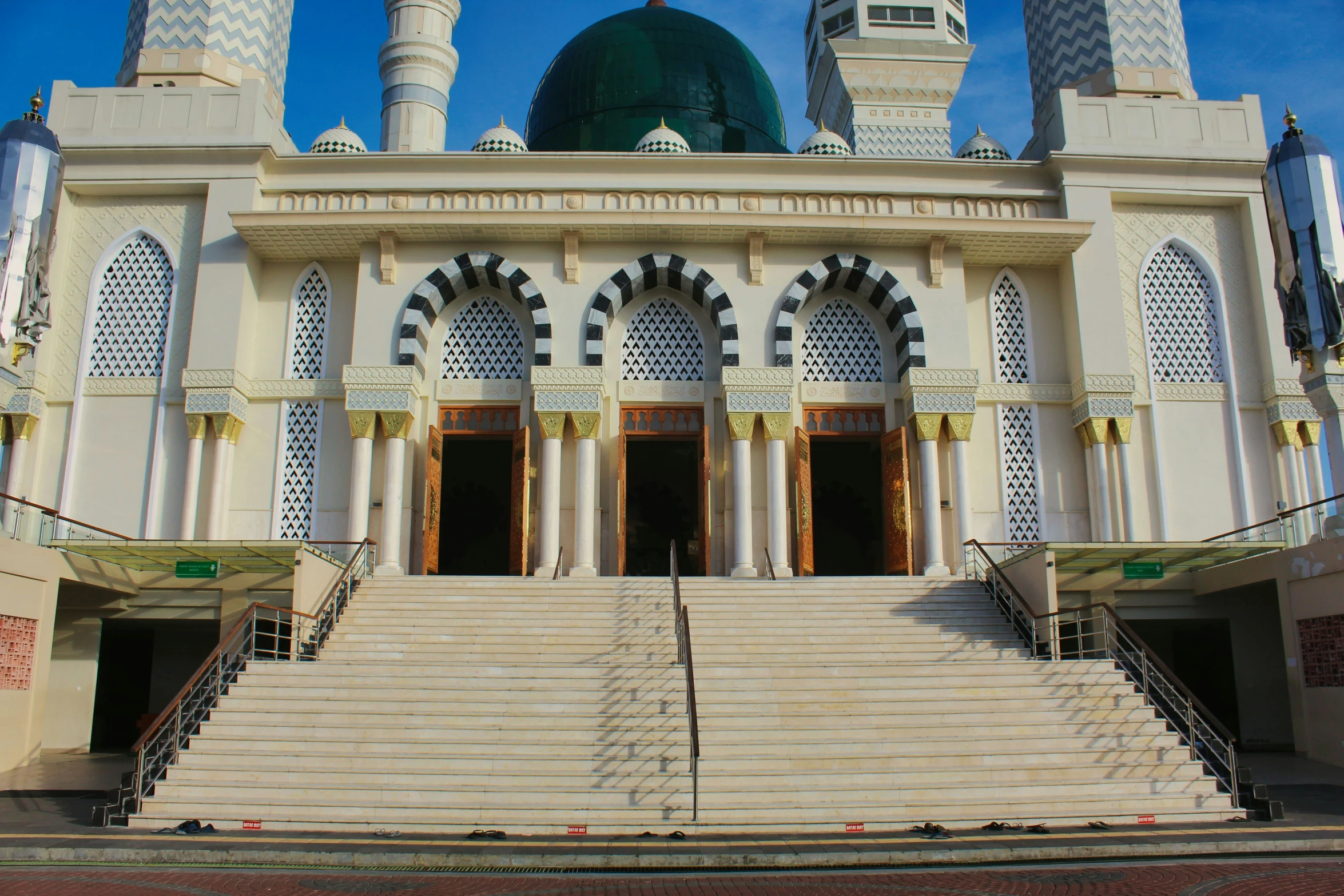 there is a large white building with two large green domes