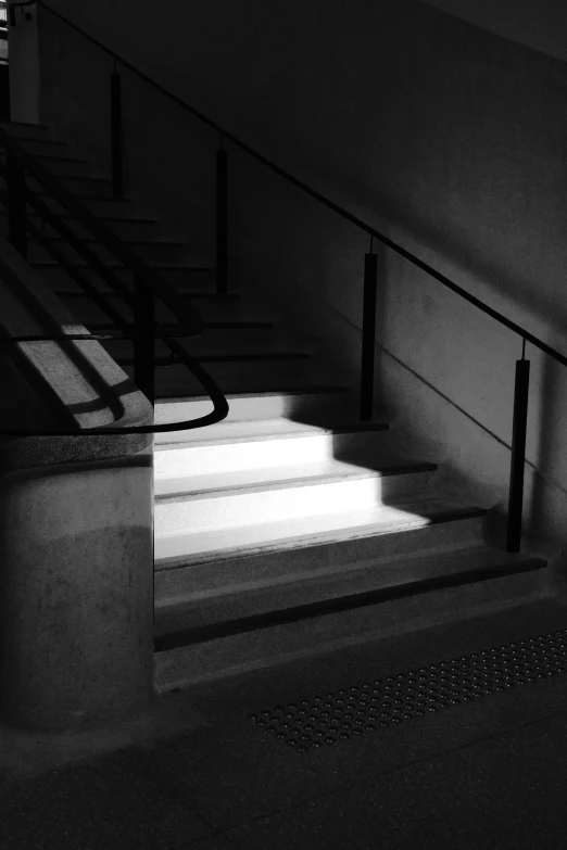 a stairway in a dimly lit room with some railings