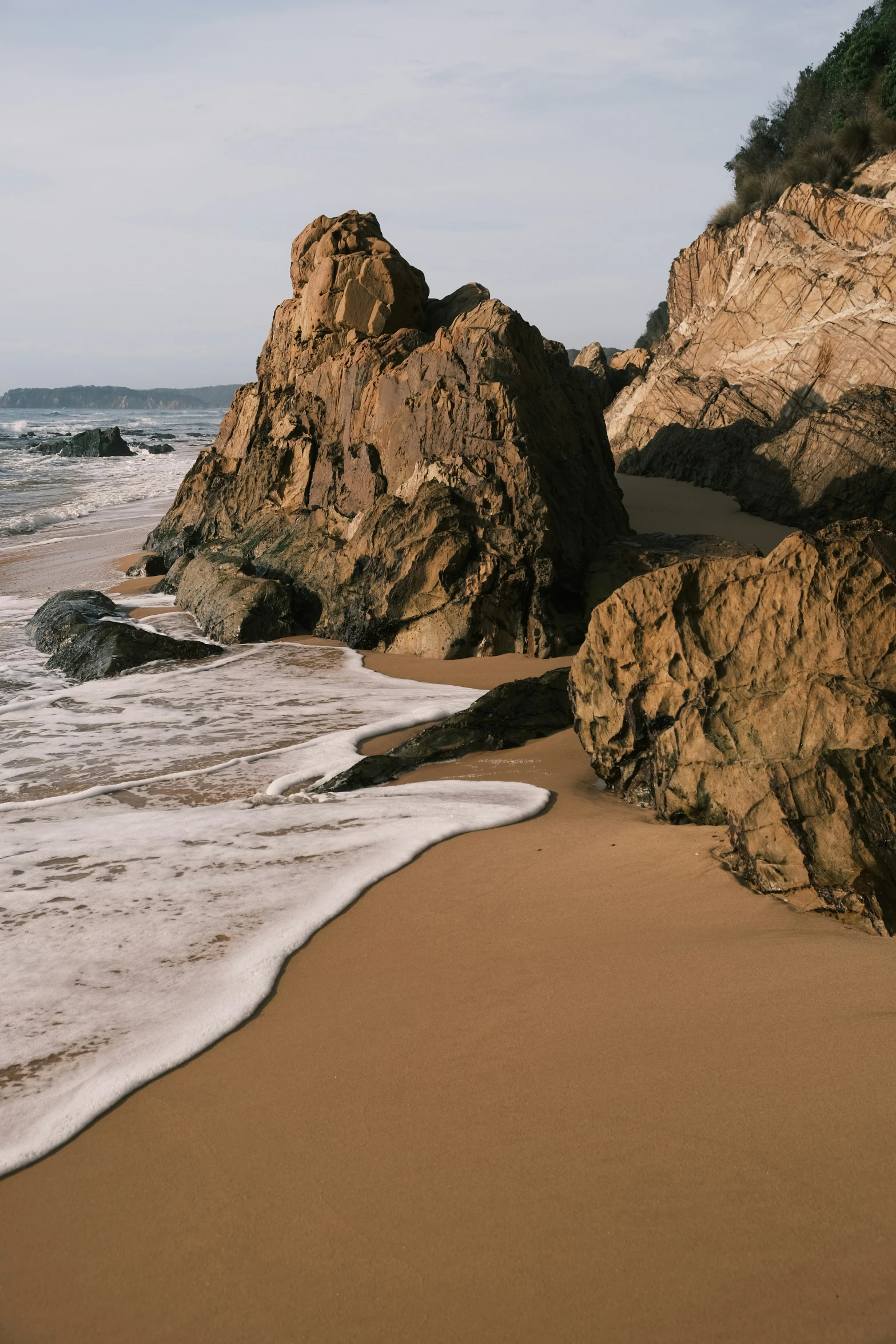 a rocky beach is next to the water