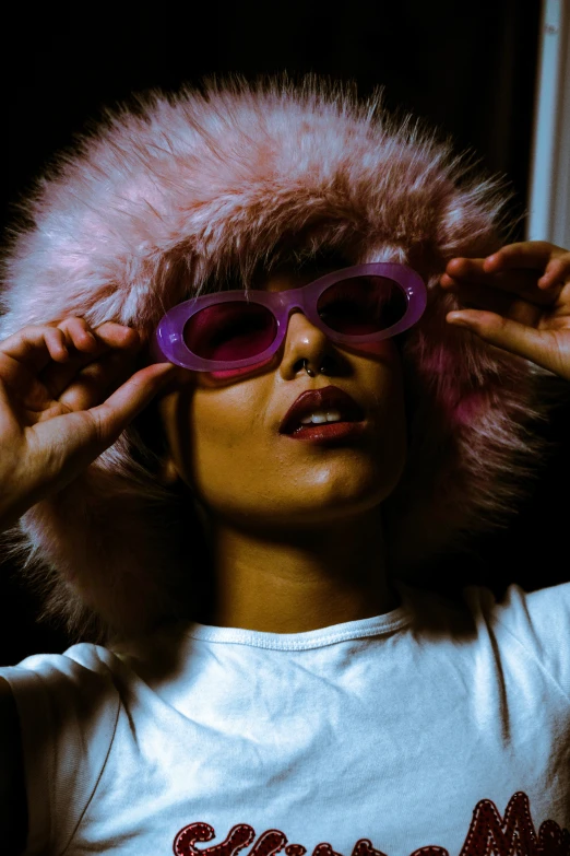 a young woman with a fur hat and glasses