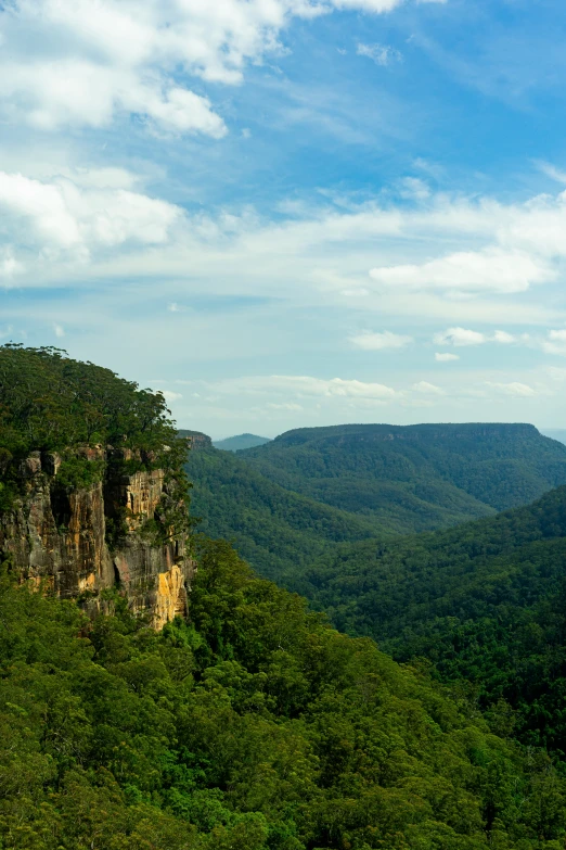 a mountain range with green vegetation and rocks