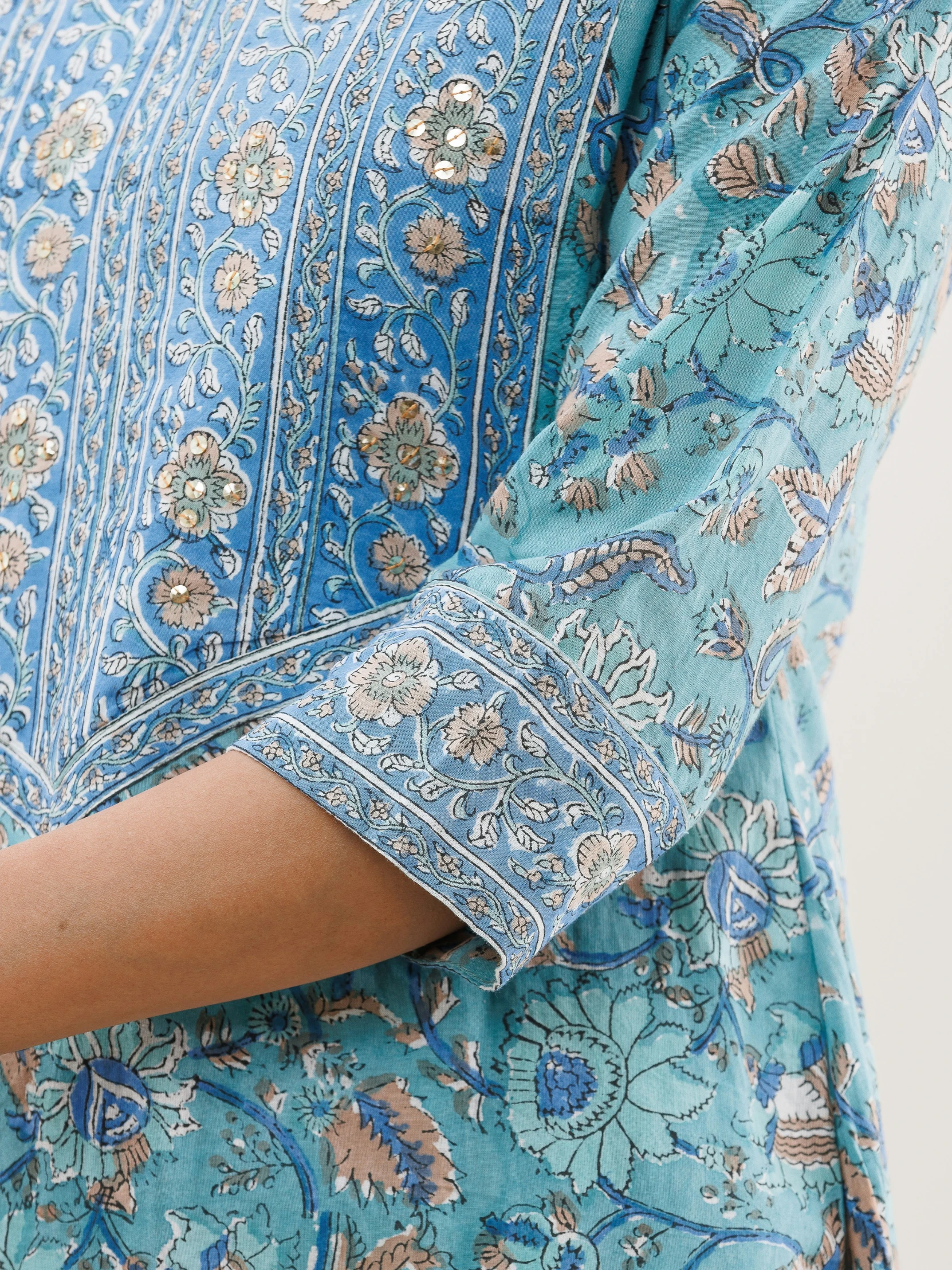 woman in blue and gold indian embroidered top