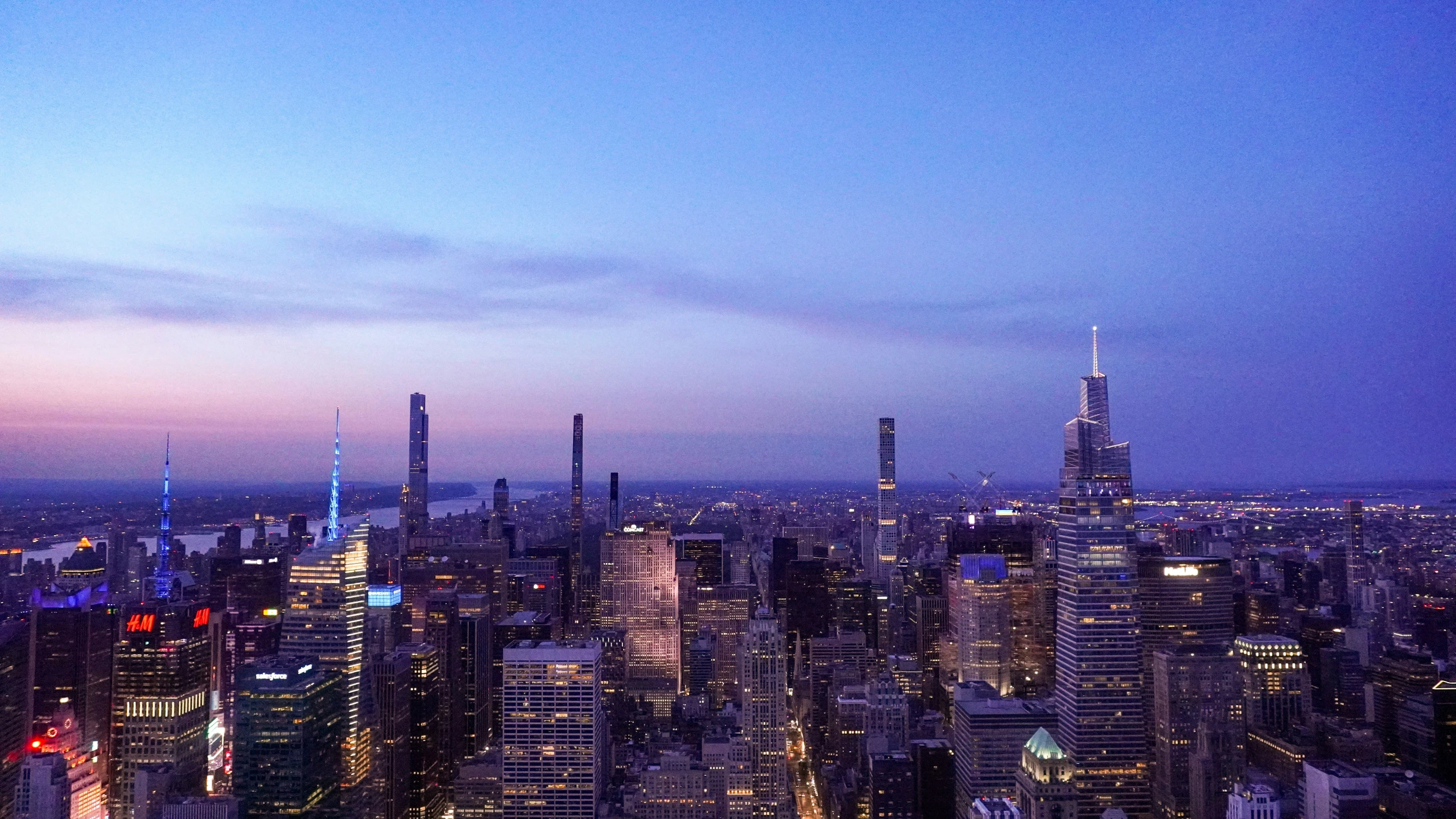 a city filled with tall buildings and a blue sky