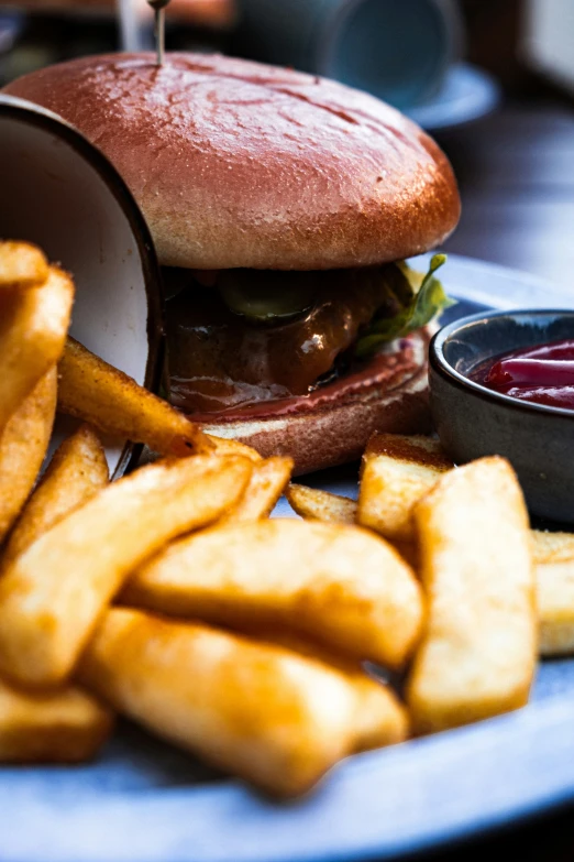 a large sandwich sitting on top of a plate with fries