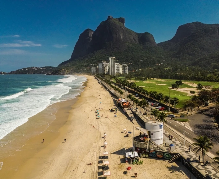 beach with a sandy shoreline and cliffs in the background